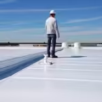 Tpo roof | two rivers roofing, inc foreman overlooking tpo roofing job