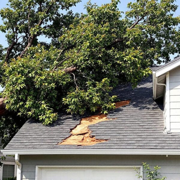 Tree damage requiring roof repair after storm causes major roof damage